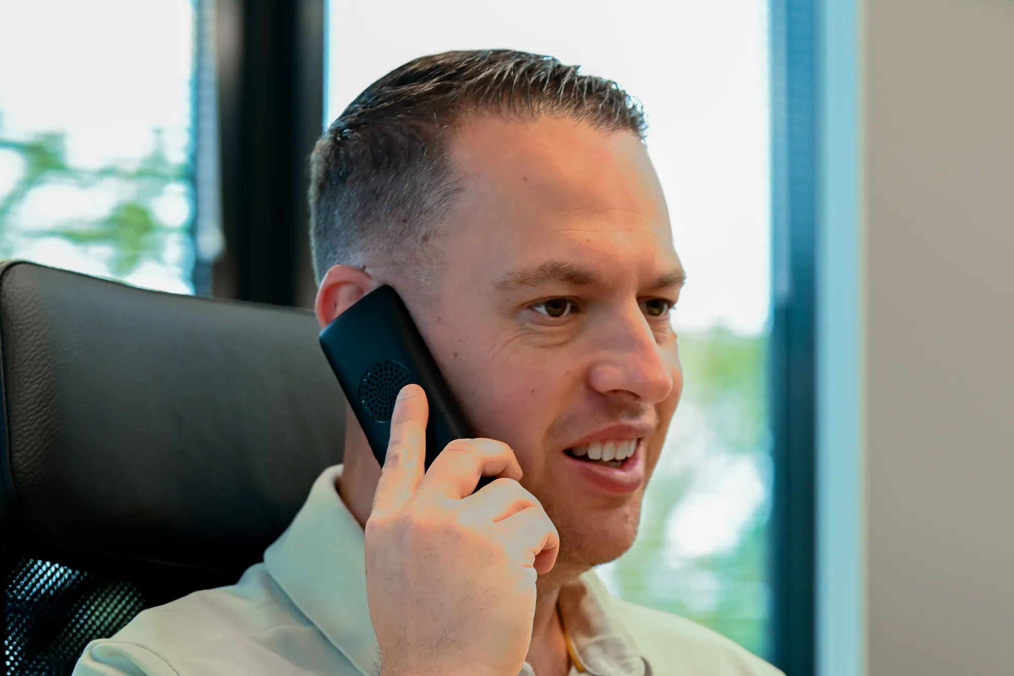 Jordy van Boutio helpt een klant telefonisch vanaf zijn bureau